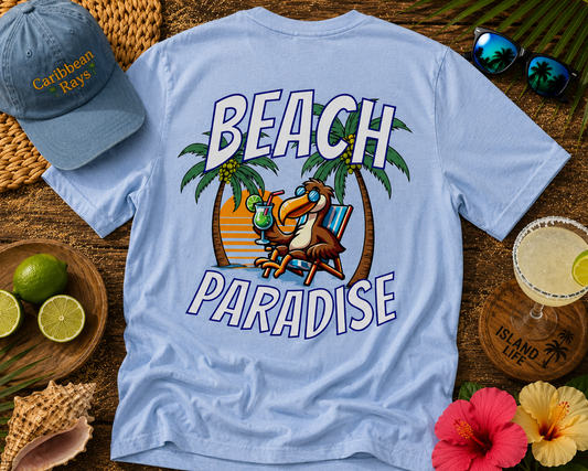 Light blue t-shirt with 'Beach Paradise' design, cap, limes, and flowers on a wooden surface.