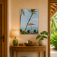 Decorative interior with a table, lamp, and artwork of a tropical scene.