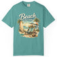 Teal t-shirt with 'Beach therapy' graphic on a white background