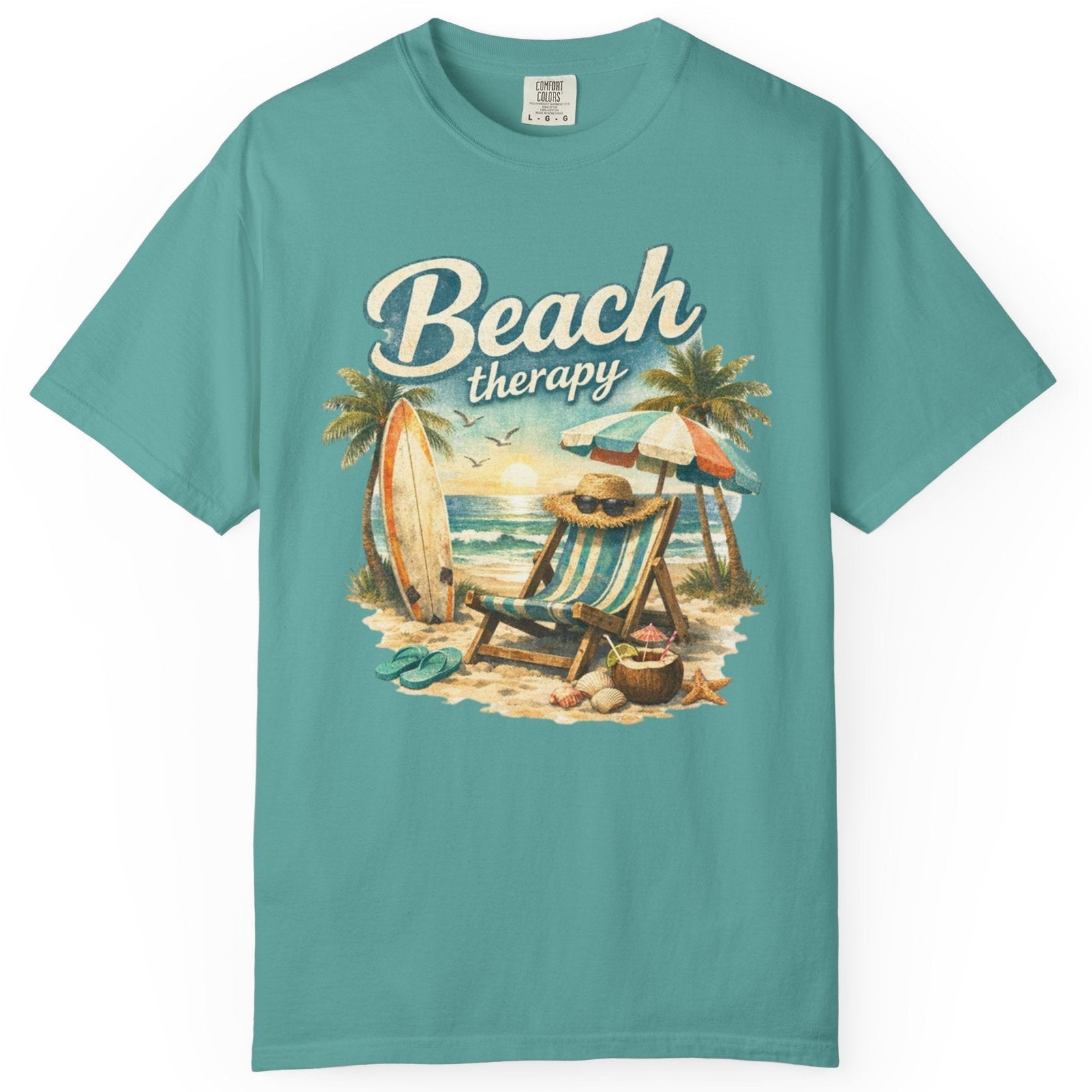 Teal t-shirt with 'Beach therapy' graphic on a white background