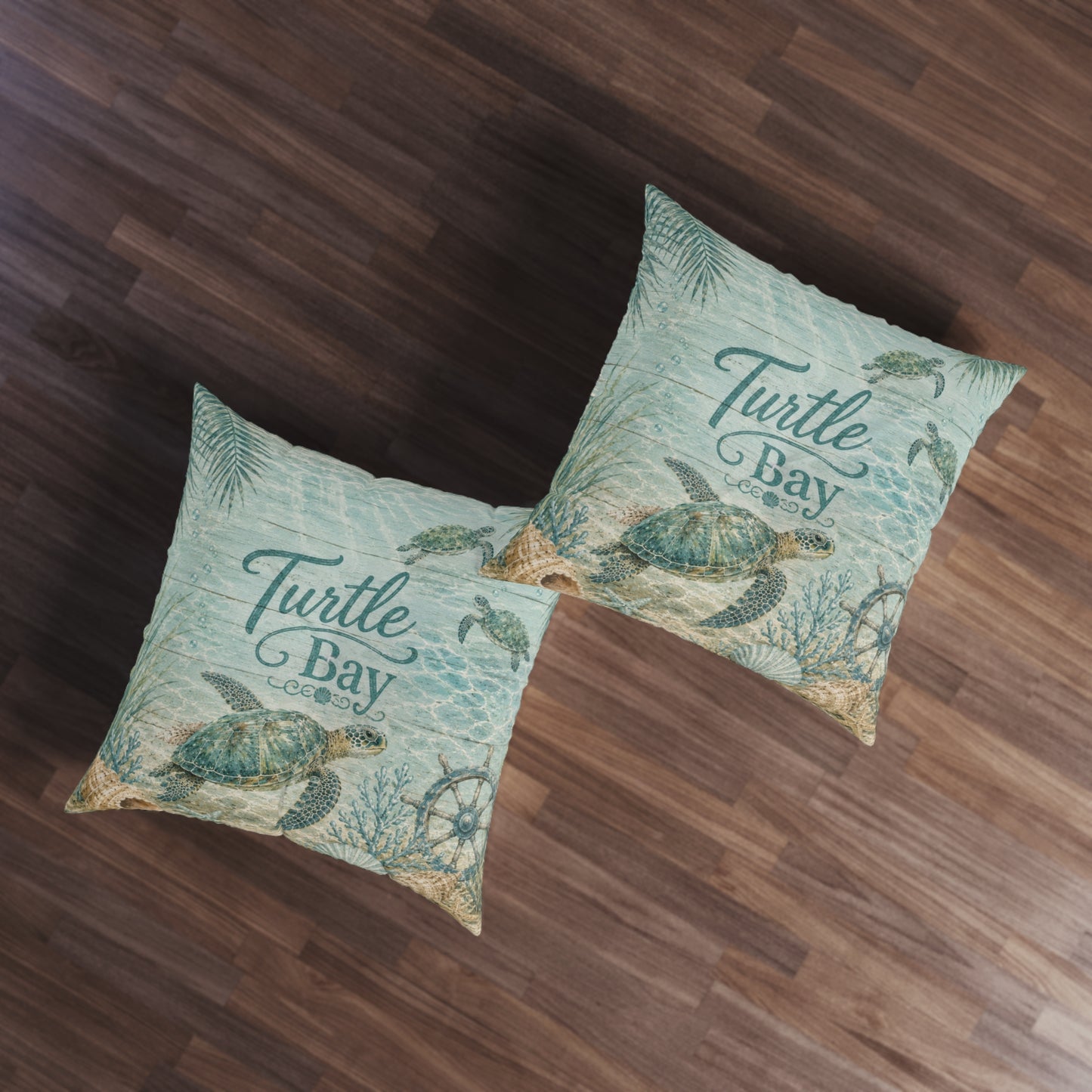Two square turquoise floor pillows with sea turtle prints and “Turtle Bay” lettering