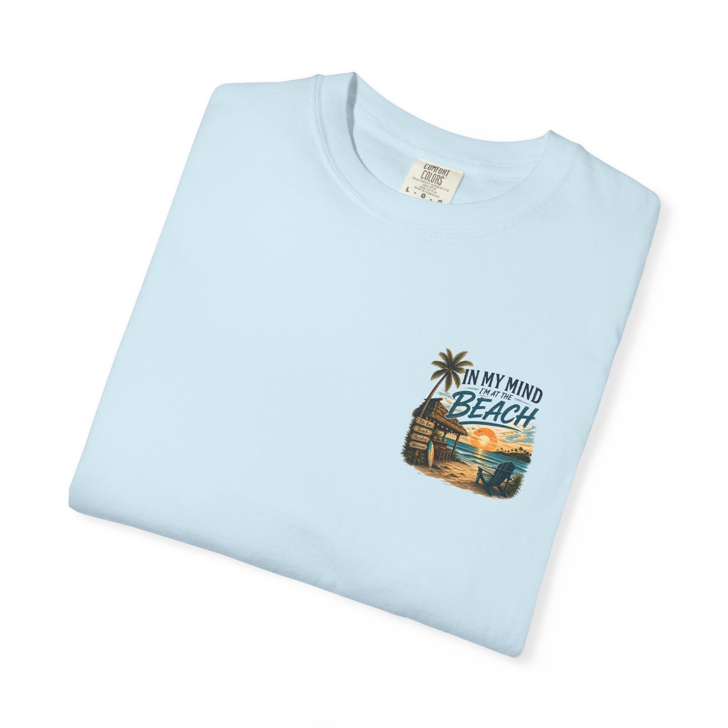 Light blue t-shirt with beach graphic and text on a white background