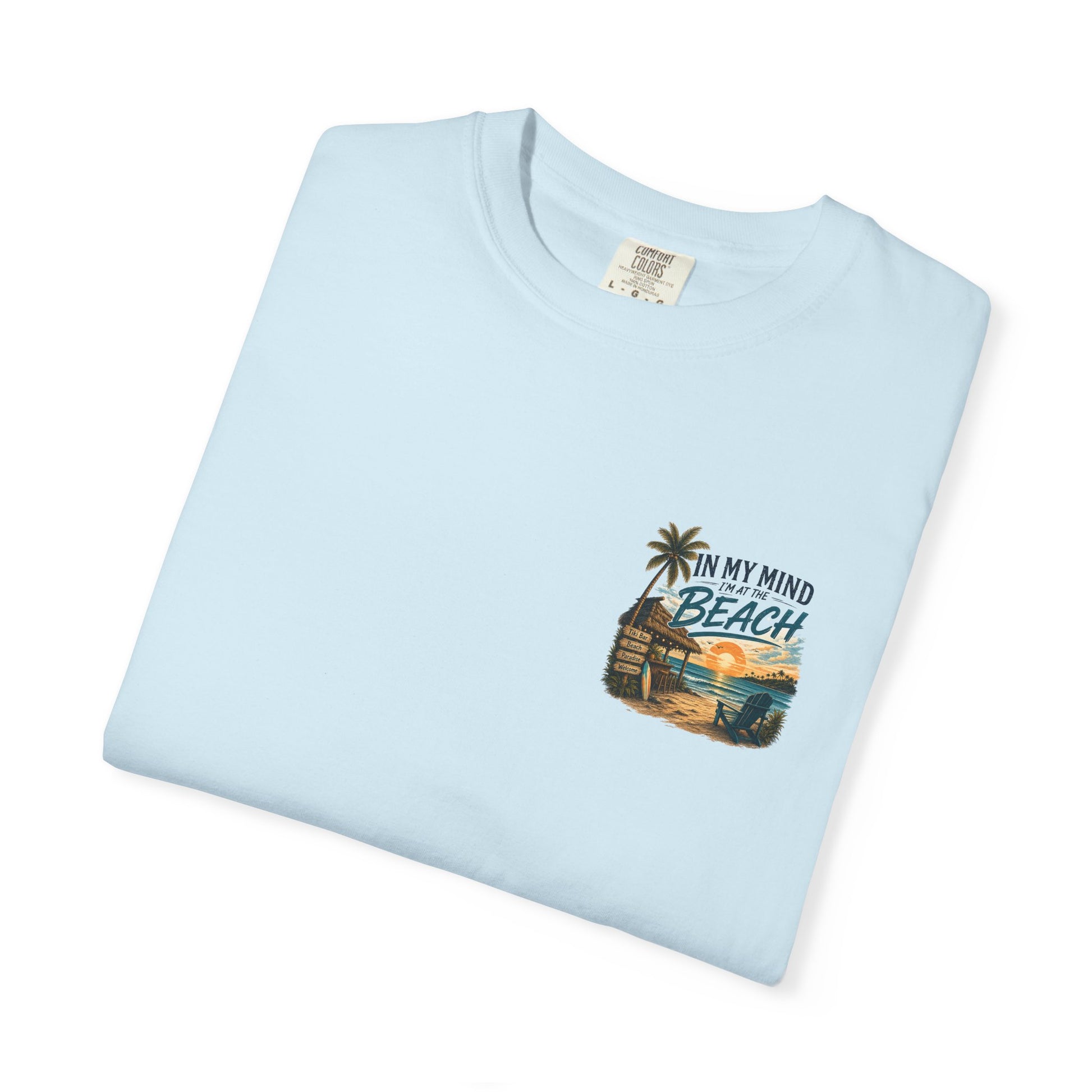 Light blue t-shirt with beach graphic and text on a white background