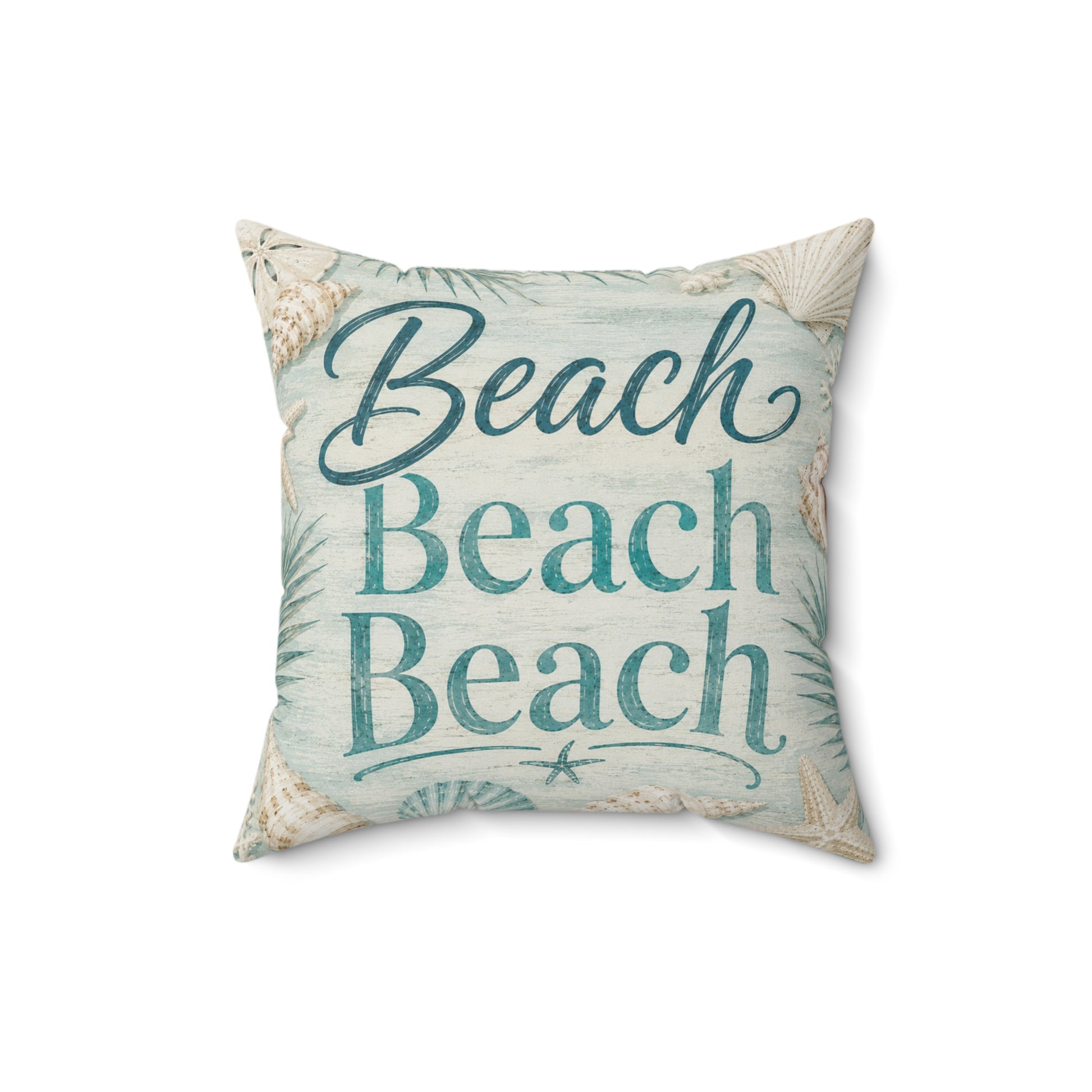 A square decorative throw pillow with a beach theme, featuring the words 'Beach Beach Beach' in teal script and block lettering on a light blue and white textured background with seashell and palm leaf illustrations.