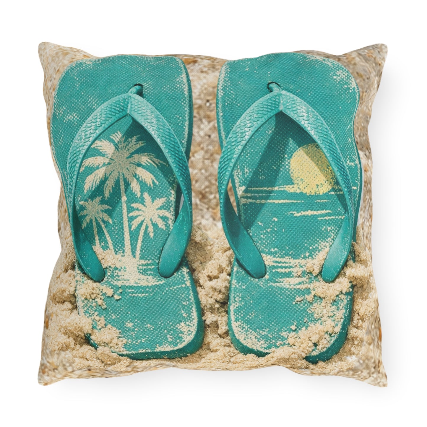 Pillow with teal flip-flops on a sandy background