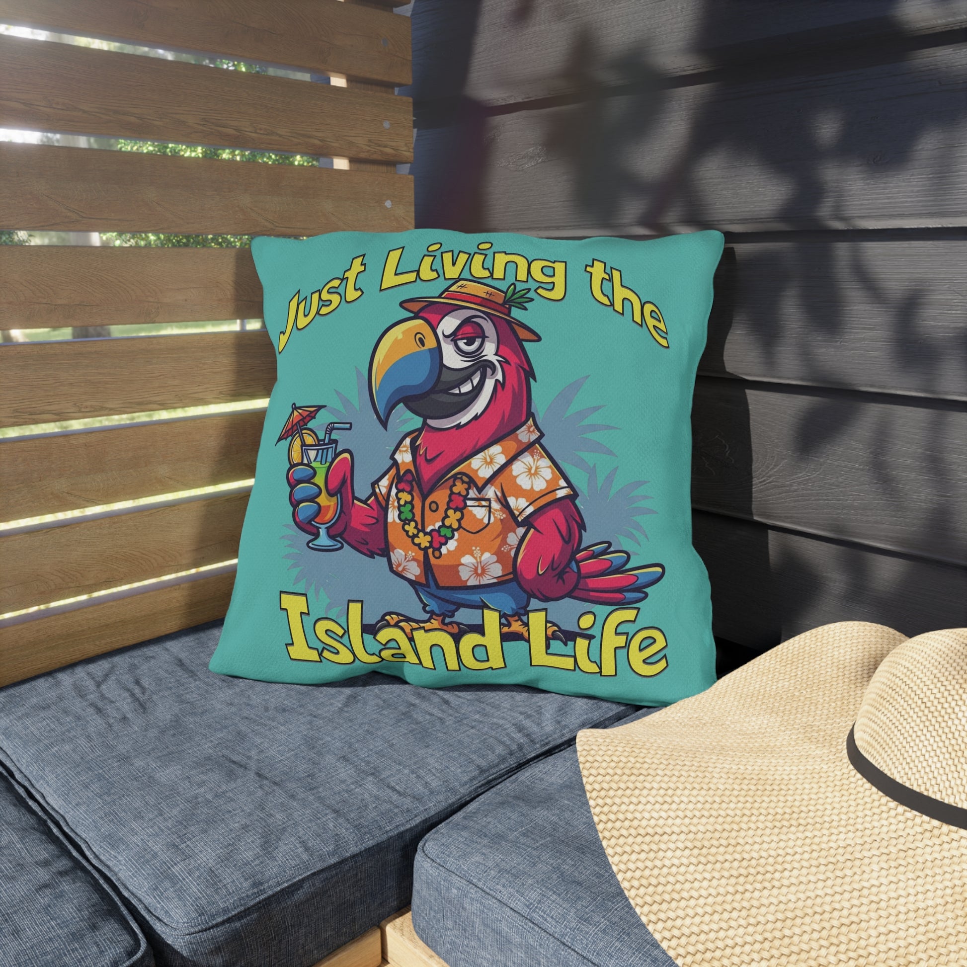 Decorative pillow with a parrot design and 'Just Living the Island Life' text on a bench.