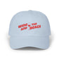 Light blue cap with red text 'Wine and Beach' on a white background