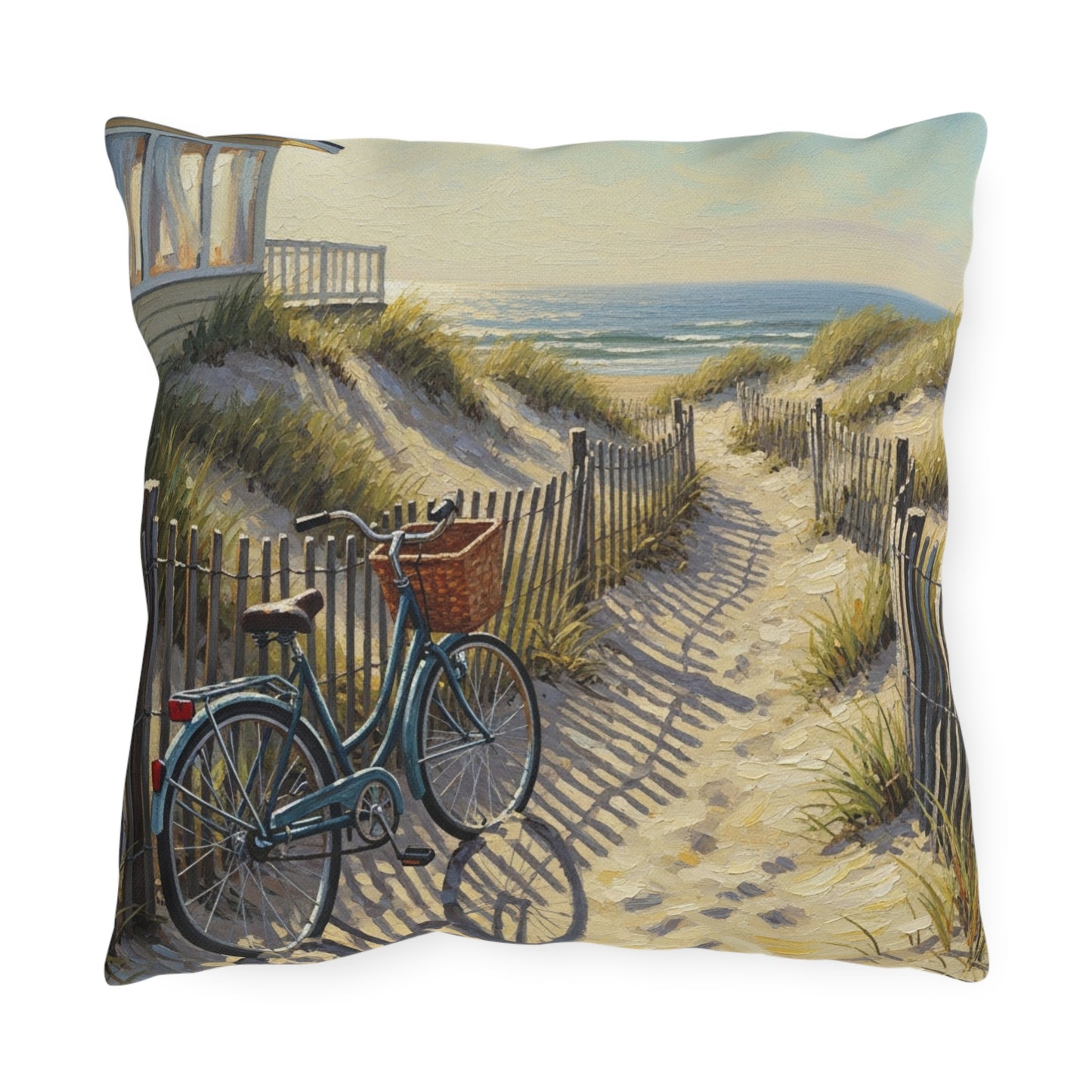 Decorative pillow with a beach scene featuring a bicycle on a sand path.
