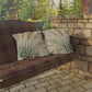 Wooden porch swing with plaid cover and patterned cushions on a stone patio.