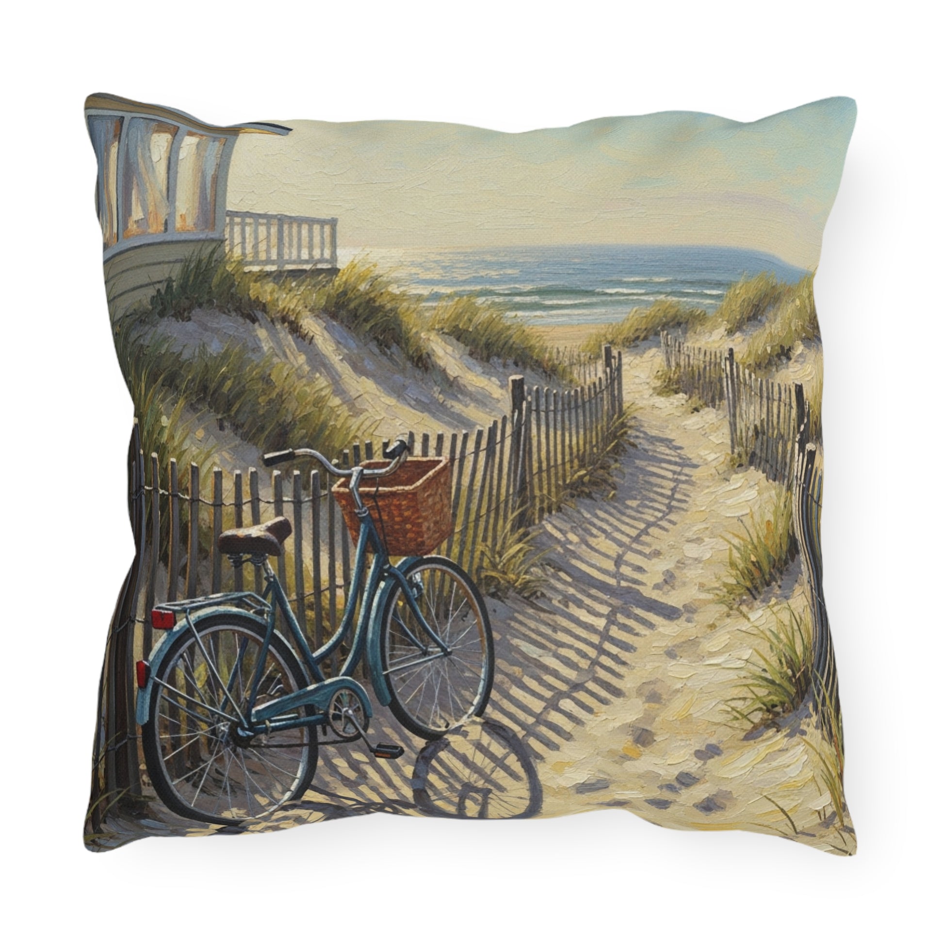 Decorative pillow with a beach scene featuring a bicycle and a house.