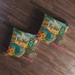 Square tufted floor pillow, Key West themed print with teal chair scene, shown at an angle.