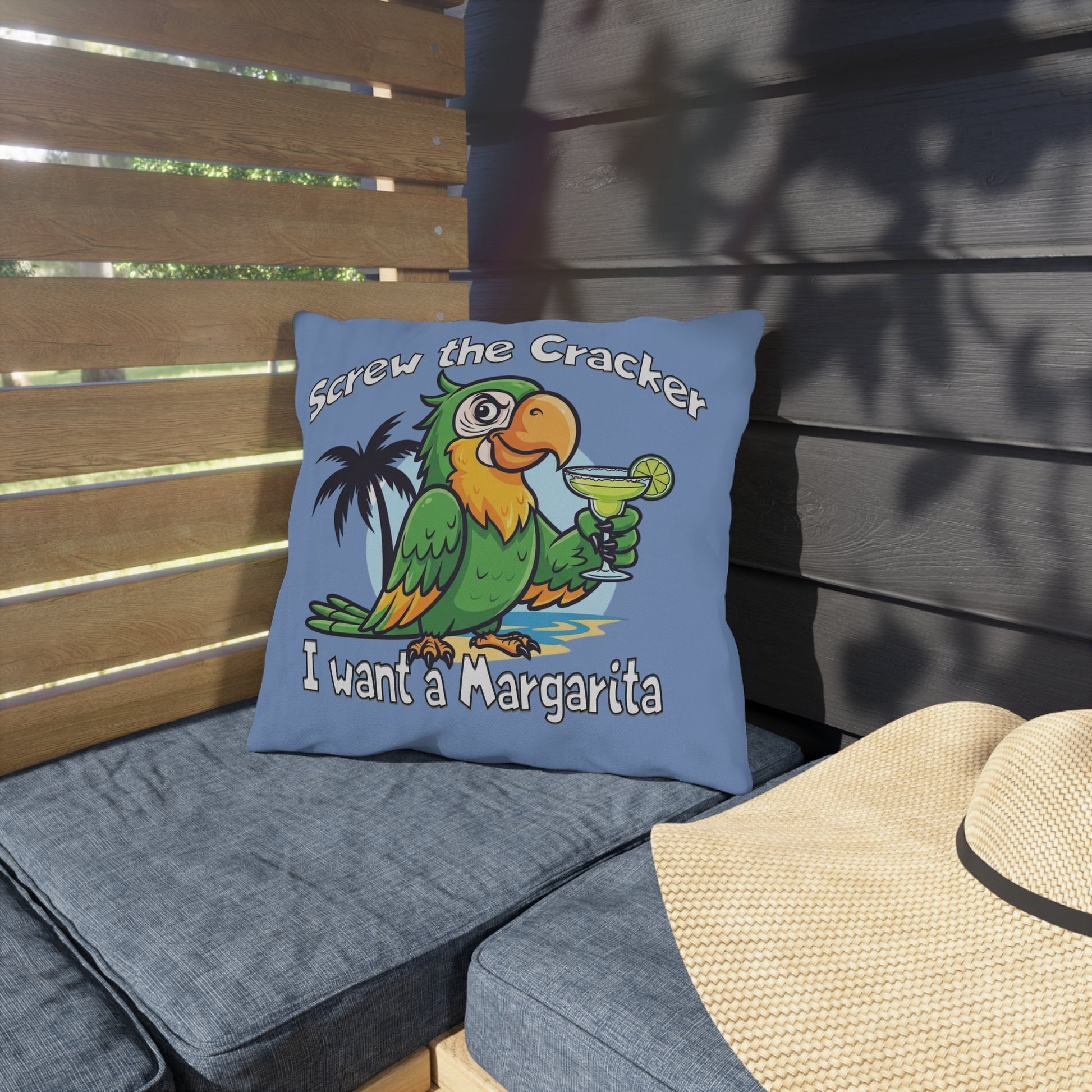 Blue pillow with a parrot graphic and text on a wooden bench