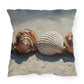 Decorative pillow with shell design on a white background