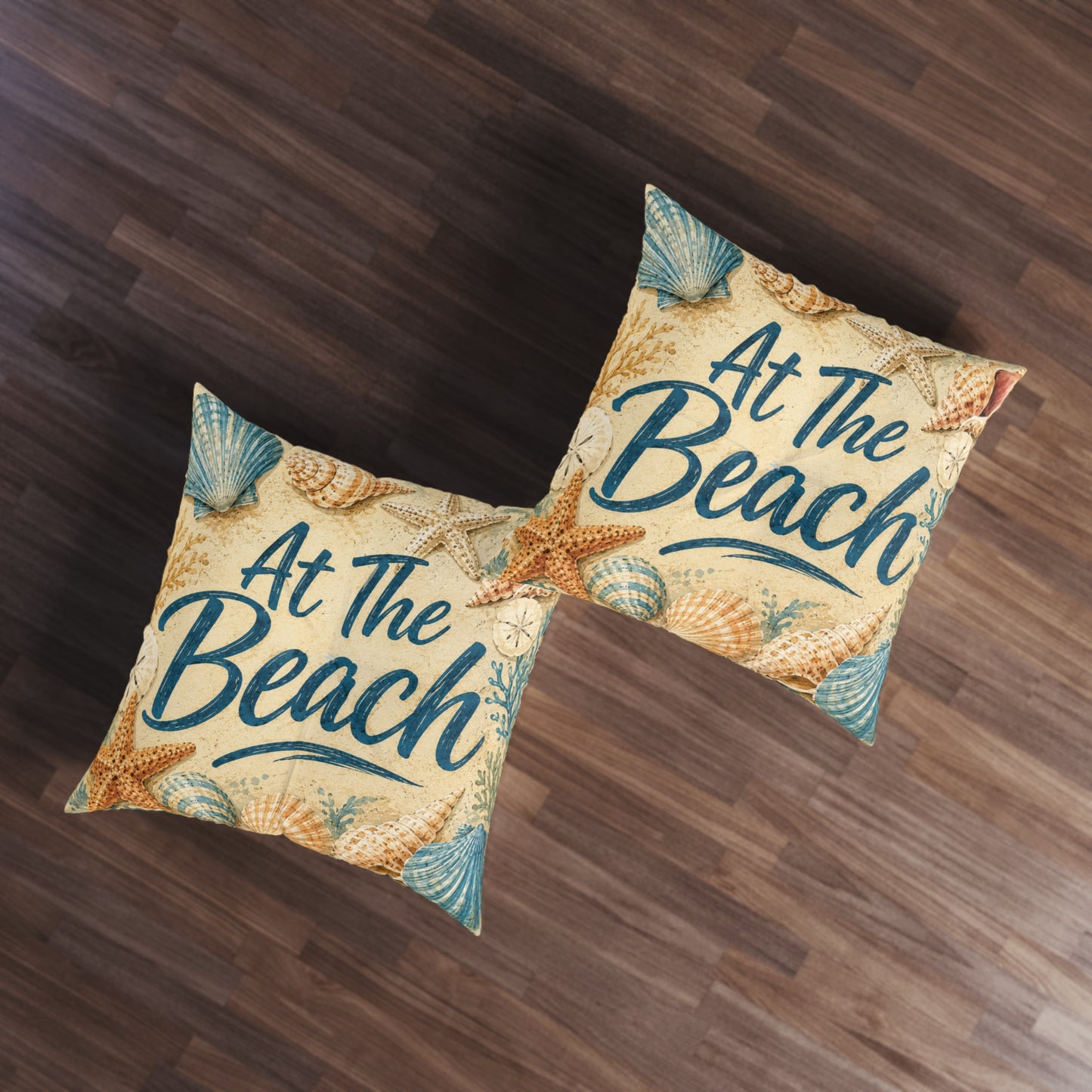 Square tufted floor pillows, beige seashell design with teal 'At The Beach' script