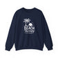 A navy blue crewneck sweatshirt with a white graphic print on the front featuring a palm tree, sunset, and the text 'BEACH Therapy IN SESSION'.