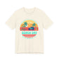 Beige t-shirt with 'Beach Day' graphic design featuring palm trees and a car on a white background at Caribbean Rays
