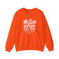 A bright orange crewneck sweatshirt with a white graphic print on the chest depicting a tiki bar scene with palm trees and the text 'Tiki Bar - Good Vibes - Cold Drinks - Island Time'.
