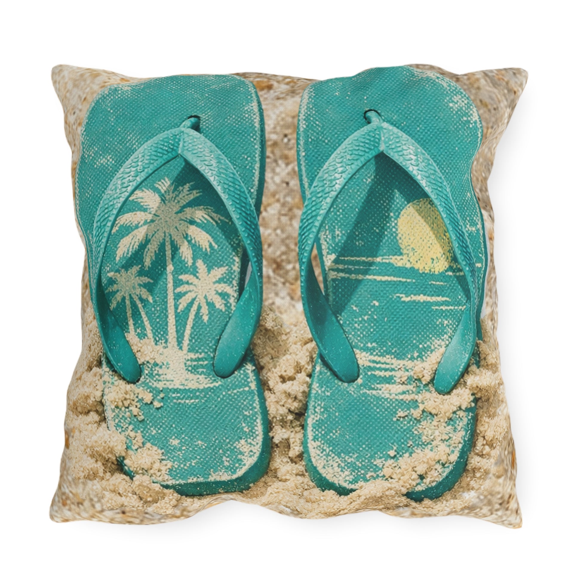 Pillow with teal flip-flops on a sand-like surface