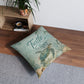 Square turquoise floor pillow with sea turtle print and “Turtle Bay” text, tufted look