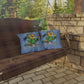 Porch swing with blue pillows featuring a parrot design and text 'I want a Margarita' on a stone patio.