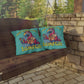 Two pillows with a parrot design and 'Island Life' text on a wooden swing.