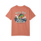 Coral t-shirt with fishing graphic and 'Reel Big Catch' text on a white background
