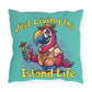 Decorative pillow with a parrot holding a cocktail and text 'Just Living the Island Life' on a teal background.