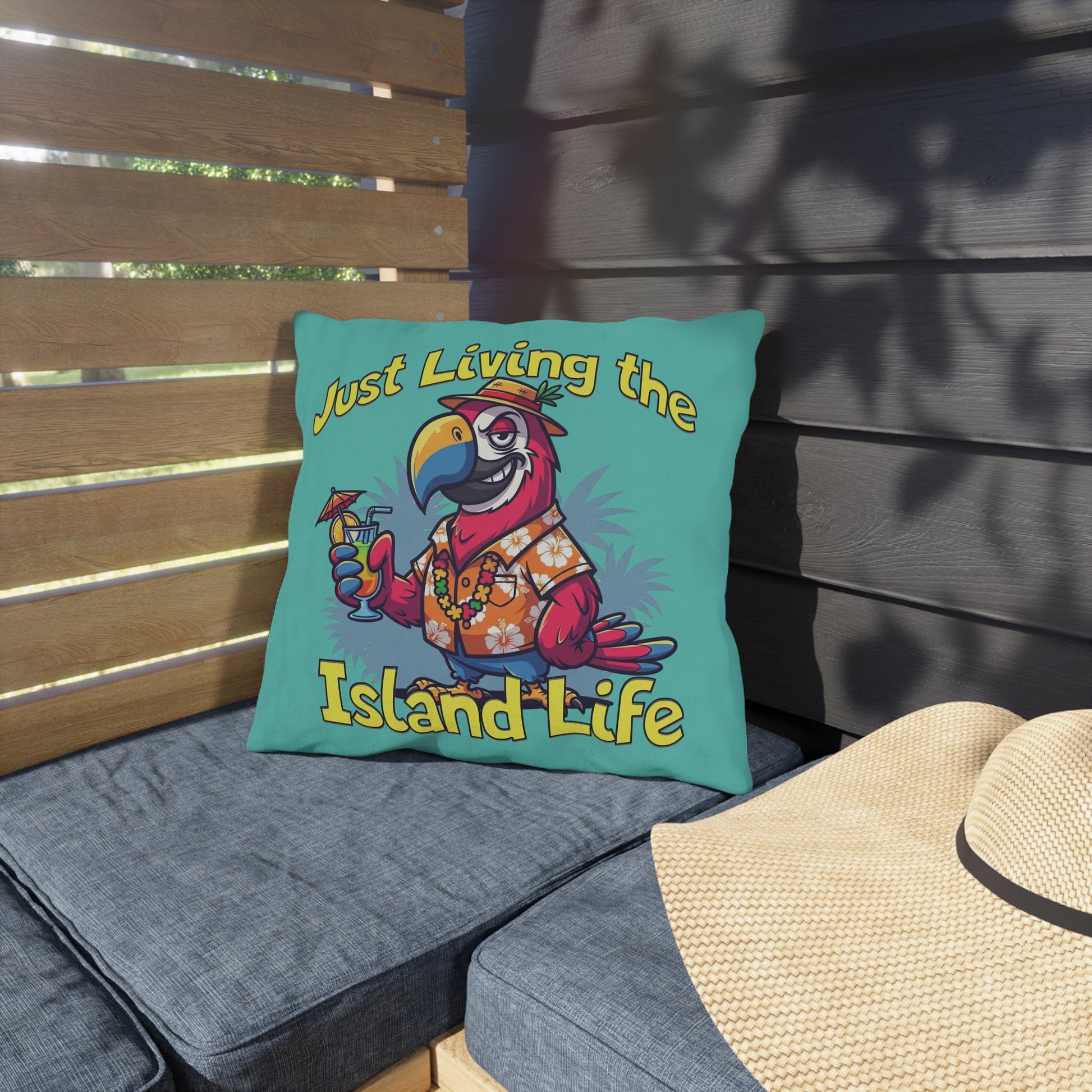 Decorative pillow with a parrot design and 'Just Living the Island Life' text on a wooden bench.