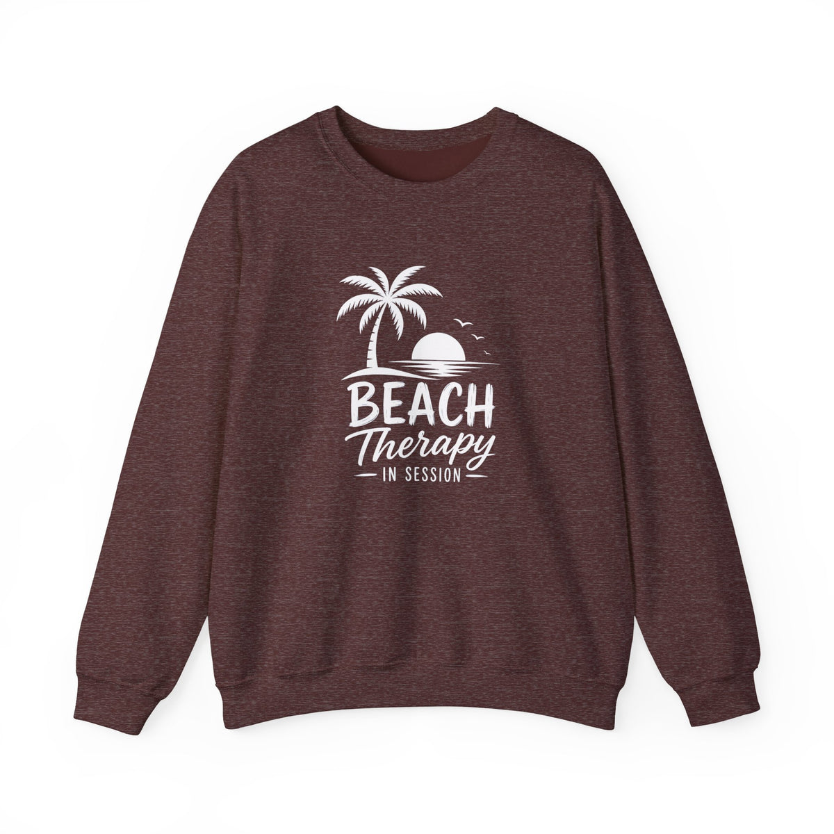 A heathered dark brown crewneck sweatshirt featuring a white graphic print of a palm tree, sunset, and the text 'BEACH Therapy IN SESSION' on the front, displayed against a solid white background.