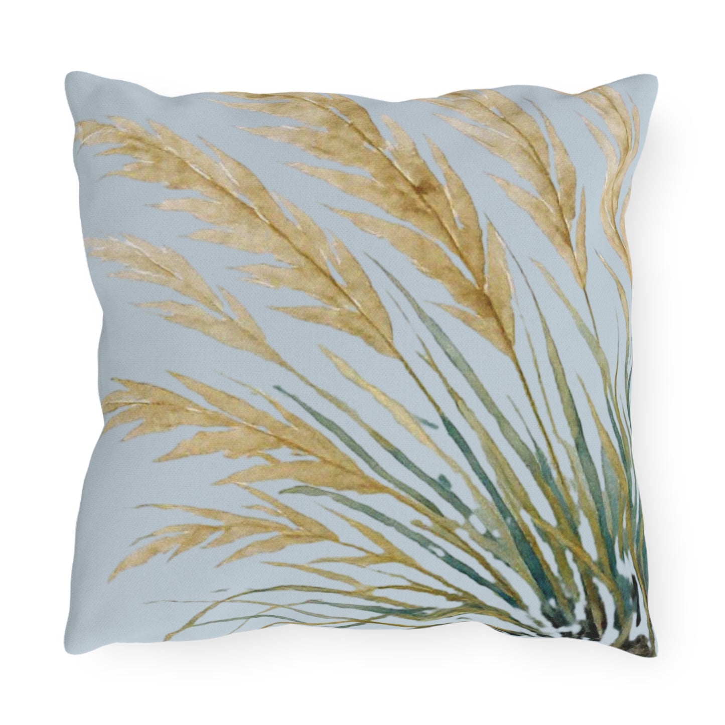 Decorative pillow with gold and green leaf pattern on a light blue background