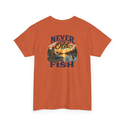 An orange short-sleeve t-shirt with a vintage-style graphic on the chest that reads 'NEVER FORGET Old FISH' surrounding a sunset lake and pine tree illustration.