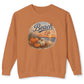 A rust-orange crewneck sweatshirt featuring a circular graphic on the chest with pumpkins, a sunset beach scene, and the words 'Beach Life' in blue script.