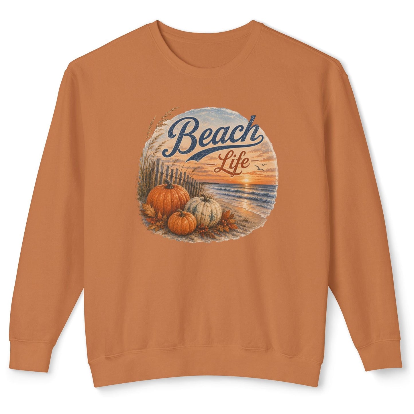 A rust-orange crewneck sweatshirt featuring a circular graphic on the chest with pumpkins, a sunset beach scene, and the words 'Beach Life' in blue script.