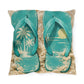Teal flip-flops with beach scene design on a textured surface