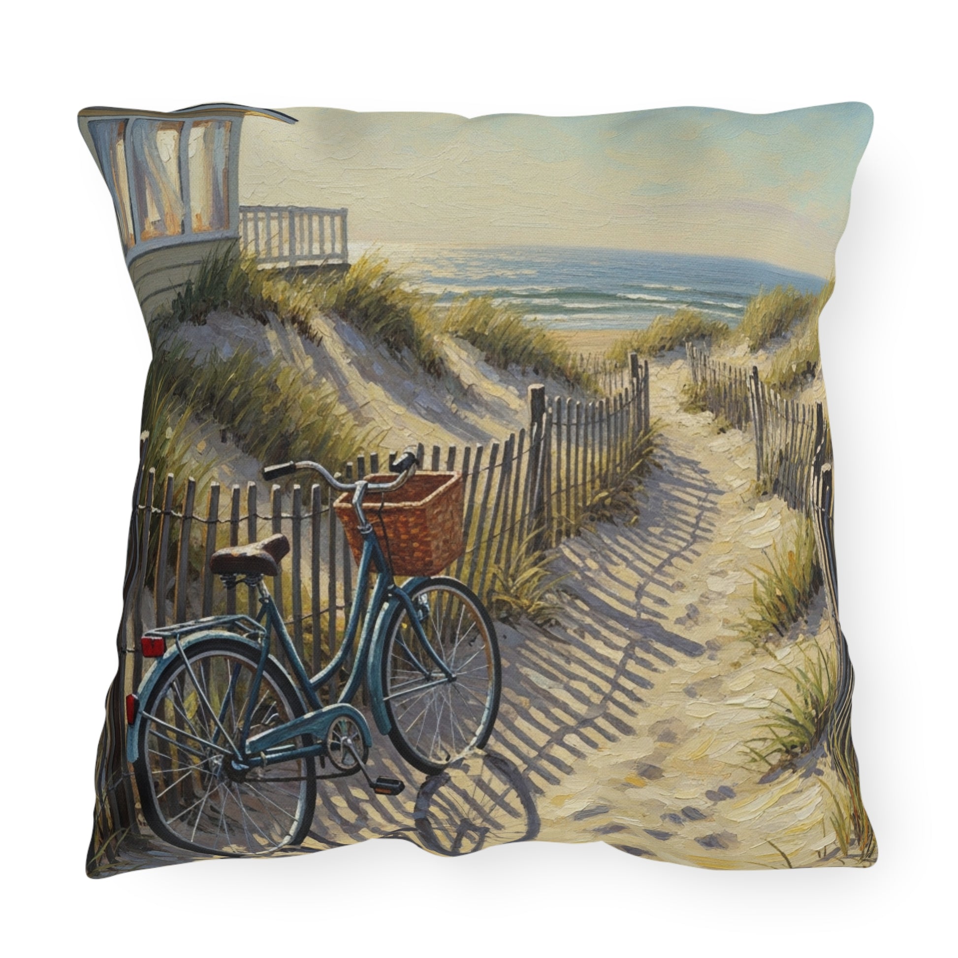Decorative pillow with a beach scene featuring a bicycle and sand dunes.