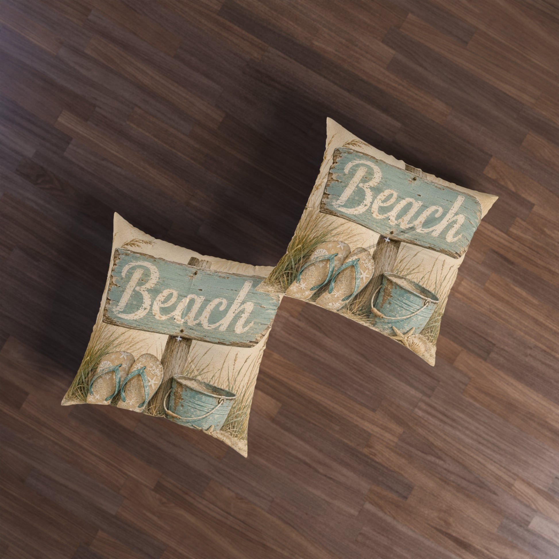 Square beach-themed floor pillow, beige fabric with teal “Beach” print and shells