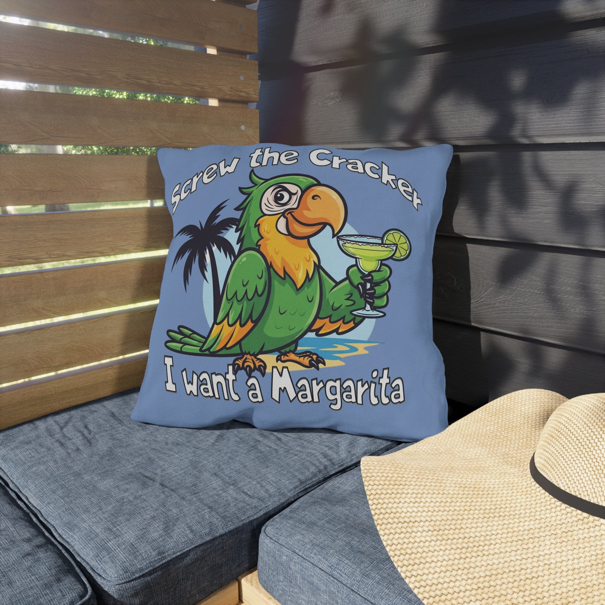 Blue pillow with a parrot graphic and text on a wooden bench