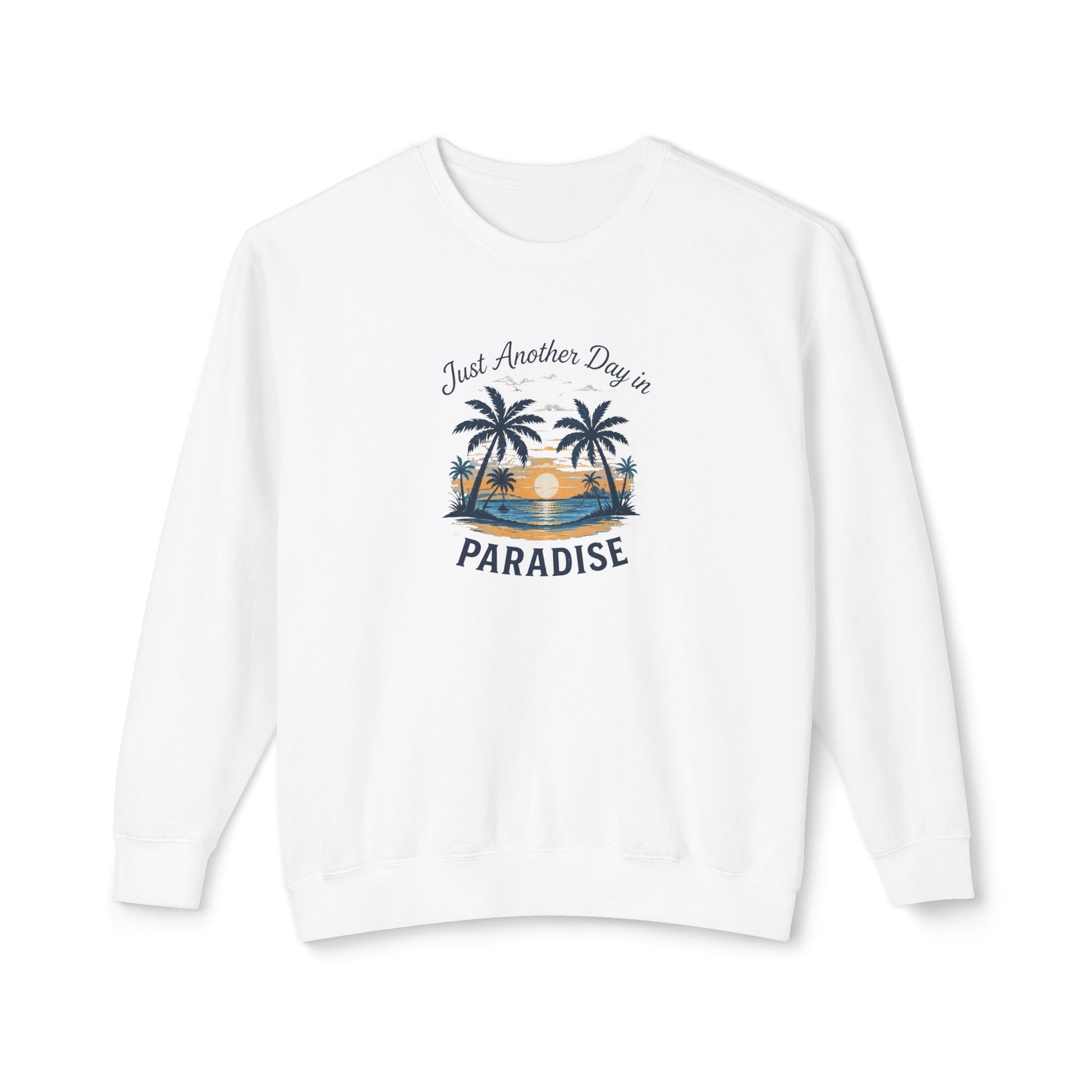 A white crewneck sweatshirt with a tropical beach graphic on the chest featuring palm trees, a sunset, and the text 'Just Another Day in PARADISE'.