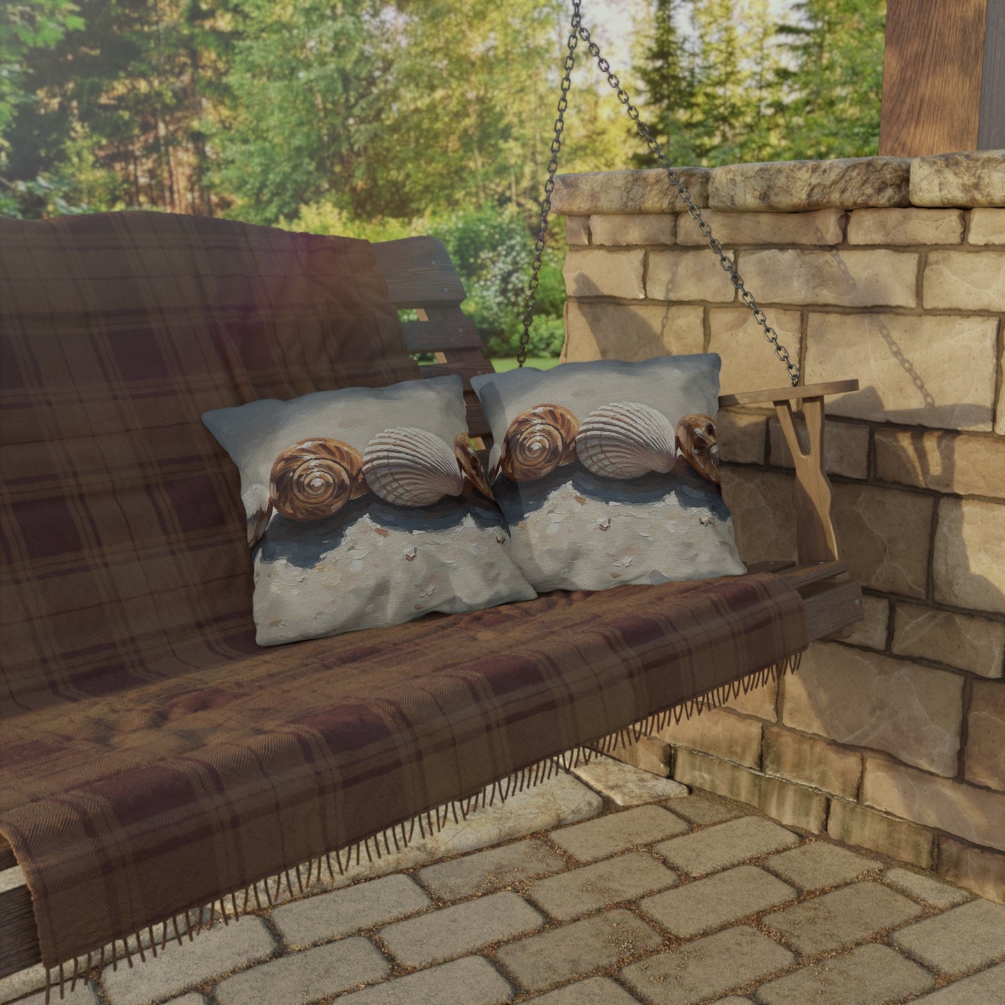 Wooden swing with plaid blanket and decorative pillows on a stone patio