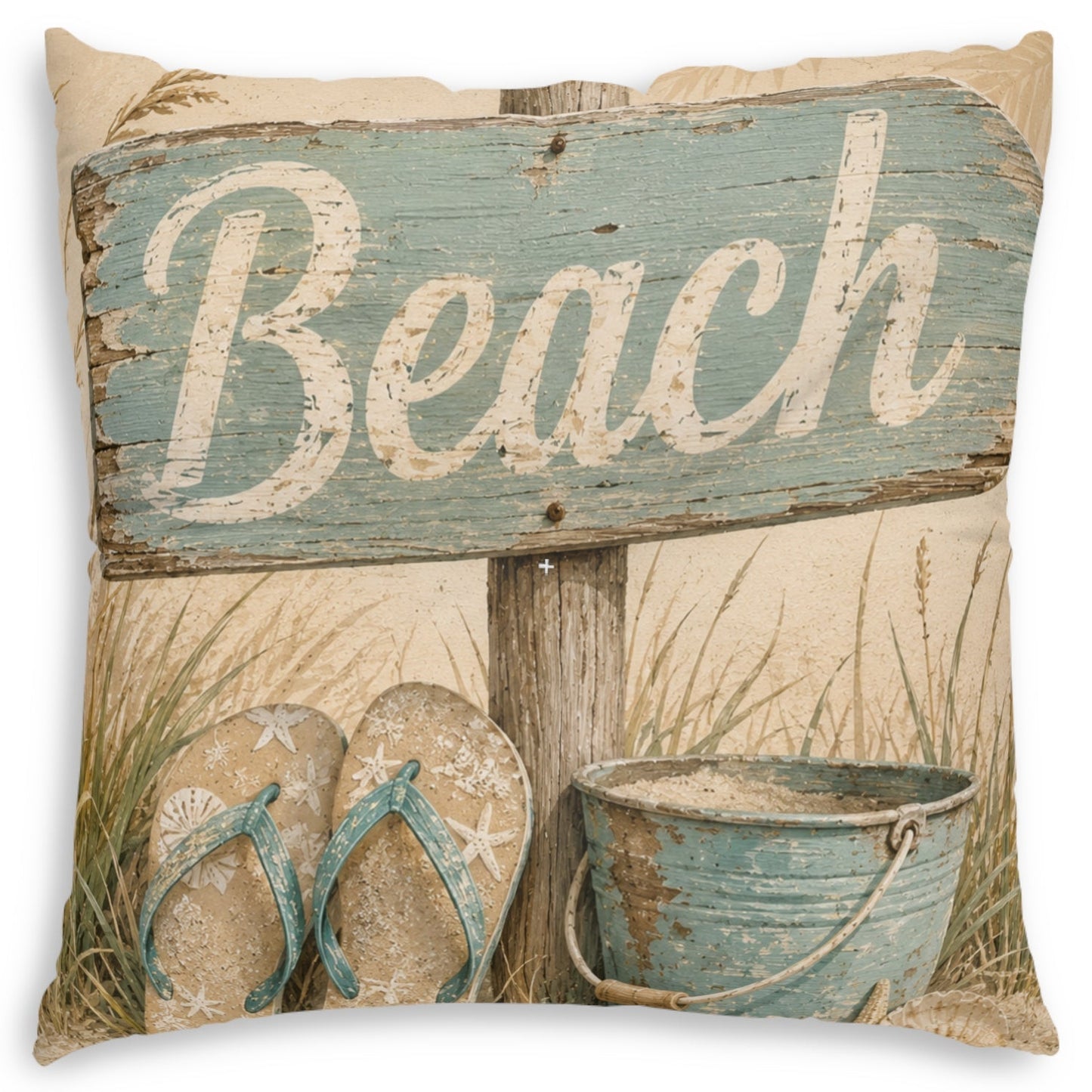 A square decorative throw pillow featuring a rustic beach-themed print with a weathered blue sign that reads 'Beach,' sand, grass, flip-flops, and a metal bucket on a cream background.