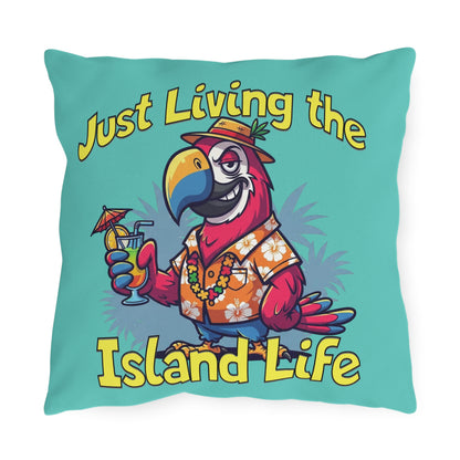 Pillow with a cartoon parrot holding a cocktail and text 'Just Living the Island Life' on a teal background