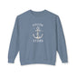 A dusty blue crewneck sweatshirt with a white anchor graphic and the words 'FOLLOW THE STARS' printed on the chest, displayed against a plain white background.