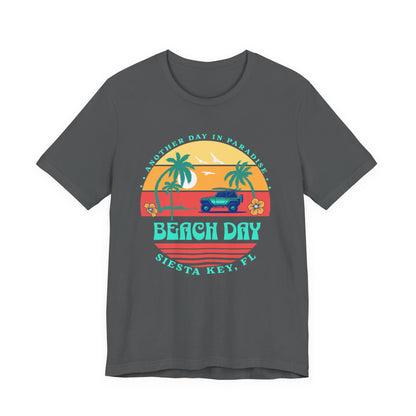 Gray t-shirt with a 'Beach Day' graphic design featuring palm trees and a sunset by Caribbean Rays