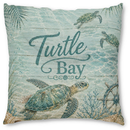 Square decorative throw pillow featuring a sea turtle and coral reef design with the words 'Turtle Bay' in teal script over a light aqua watercolor background.