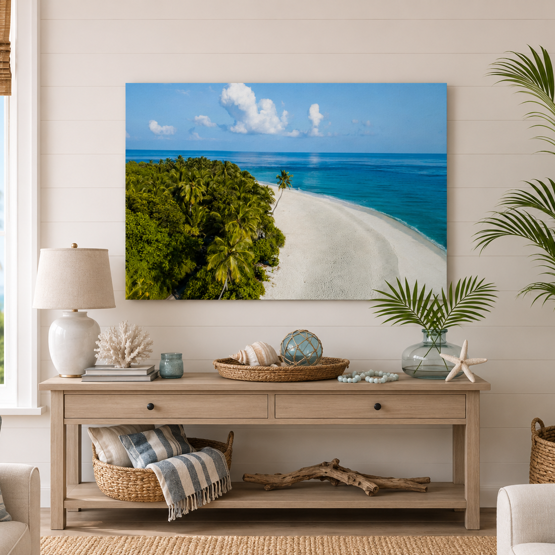 Living room with a large beach scene painting on the wall, a wooden console table with decorative items, and a window with a view of palm trees.