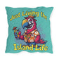 Pillow with a parrot design and text 'Just Living the Island Life' on a teal background
