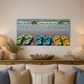 Painting of flip-flops on a beach above a sofa with decorative pillows.