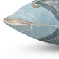 Light blue square pillow, side view with zipper pull and beige inner panel
