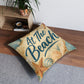 Square tufted floor pillow, beige seashell print with teal 'At The Beach' lettering