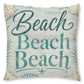 A square decorative throw pillow featuring the phrase 'Beach Beach Beach' in teal script and block lettering on a distressed light blue and off-white background, decorated with seashell and palm leaf illustrations.